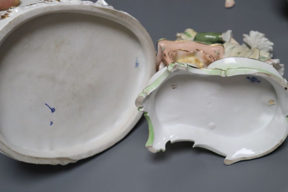 A Meissen style flower-encrusted reticulated oval porcelain jardiniere with cherub supports and three other items,